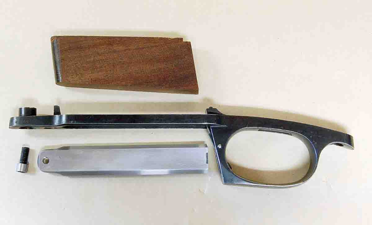 This modified magazine assembly shows a wooden spacer, a new floorplate and an attaching screw.